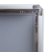 Closure system on silver anodised tamperproof poster frame.