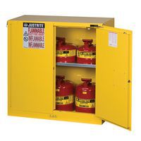 Yellow flammable storage cabinet with door open and canisters inside.